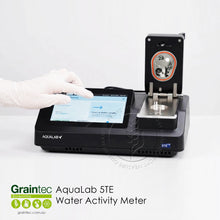 Load image into Gallery viewer, Operator using touchscreen interface on AquaLab benchtop water activity meter with open sample chamber for laboratory QA testing | Graintec Scientific
